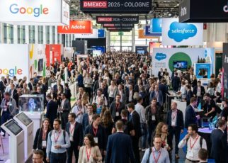 Busy expo floor at DMEXCO 2026 at Koelnmesse Cologne, with thousands of digital marketing professionals exploring exhibitor booths and tech displays