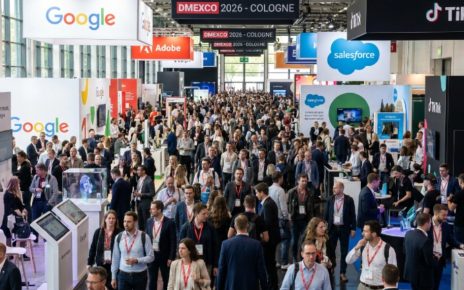Busy expo floor at DMEXCO 2026 at Koelnmesse Cologne, with thousands of digital marketing professionals exploring exhibitor booths and tech displays