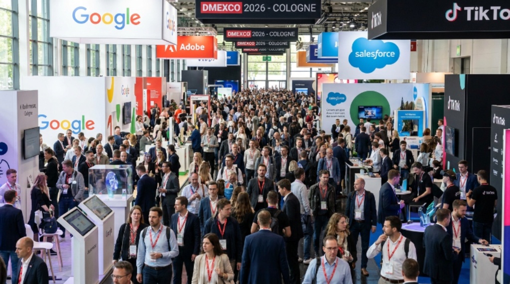 Busy expo floor at DMEXCO 2026 at Koelnmesse Cologne, with thousands of digital marketing professionals exploring exhibitor booths and tech displays